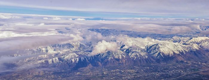 Wasatch front rocky mountain range aerial snow capped peaks winter urban salt lake city utah usa