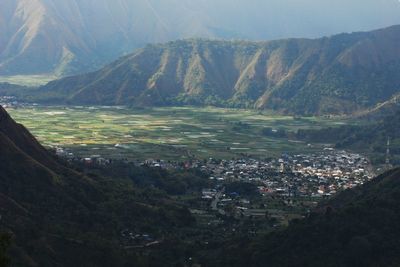 High angle view of townscape and mountains against sky