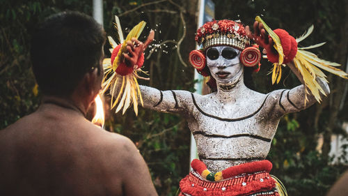Rear view of man statue at temple
