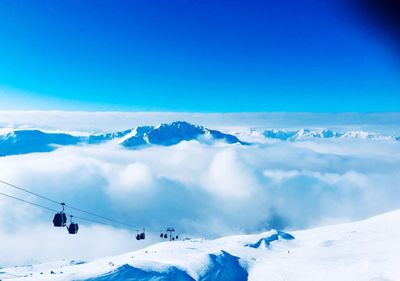 Scenic view of snowcapped mountains against blue sky