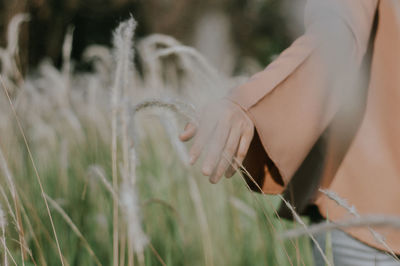 Midsection of woman on field