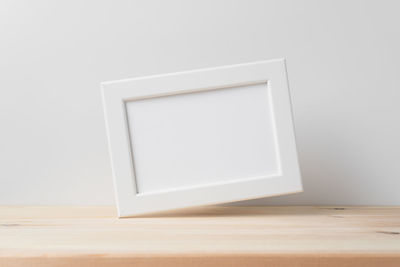 Close-up of wooden table against white background