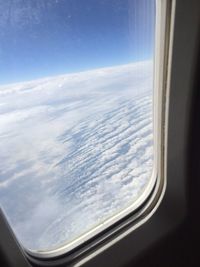 Aerial view of clouds seen from airplane window