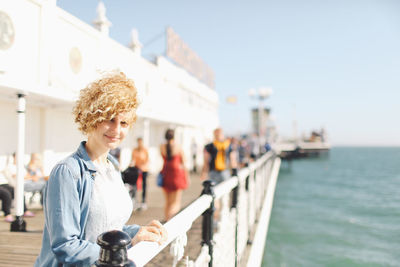 Portrait of woman at brighton pier against sky