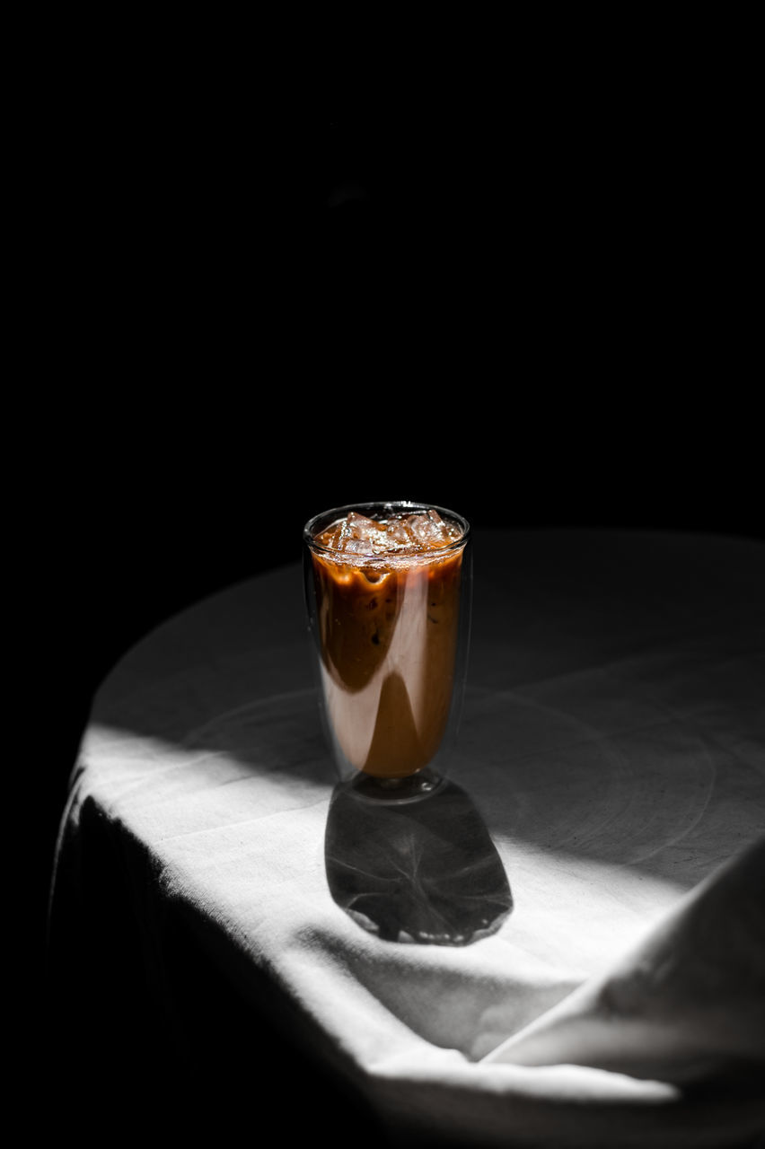 food and drink, drink, glass, refreshment, drinking glass, black background, indoors, household equipment, alcoholic beverage, still life, table, freshness, coffee, food, darkness, no people, studio shot, black, soft drink, distilled beverage, dark, shadow, copy space, lighting, light