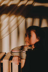 Portrait of girl looking away at home