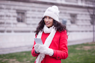 Portrait of smiling woman standing in snow