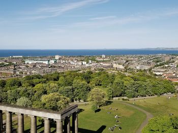 High angle view of townscape by sea against sky