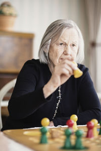 Senior woman playing ludo at nursing home