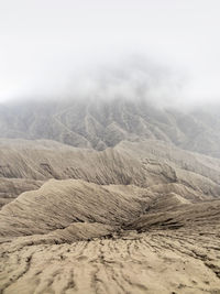 Scenic view of arid landscape against sky