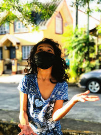 Girl wearing protective face mask playing outdoors