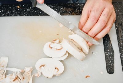 High angle view of person preparing food on cutting board