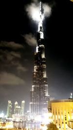 Low angle view of communications tower at night