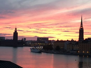 Buildings in city at sunset