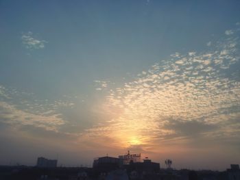 Silhouette buildings against sky during sunset