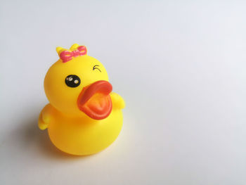 Close-up of yellow toy against white background