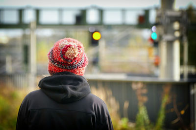 Rear view of man against blurred background