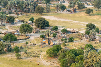 High angle view of road amidst trees and houses