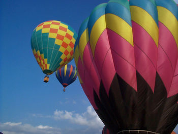 Low angle view of hot air balloon against blue sky