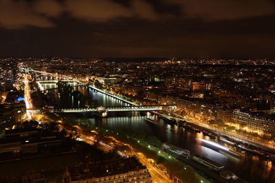 High angle view of illuminated cityscape against sky at night