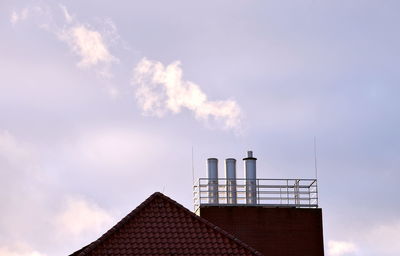 Low angle view of factory against sky