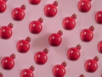 High angle view of red berries over white background