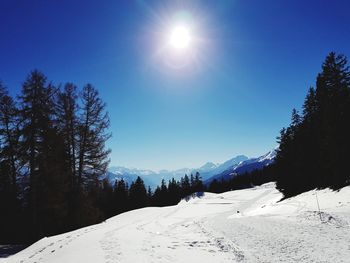 Scenic view of snowcapped mountains against clear blue sky