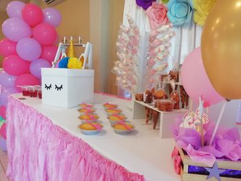 Multi colored balloons on table at home