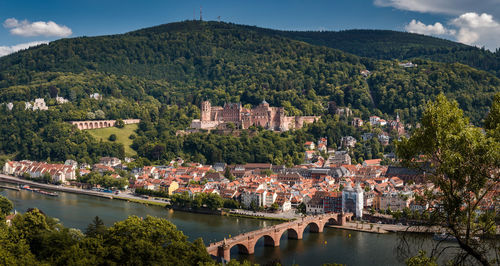 Arch bridge over river amidst buildings in town