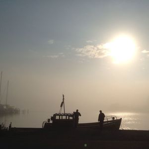 View of people in sea at sunset