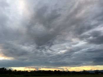 Low angle view of storm clouds over landscape