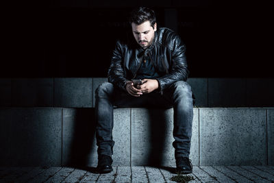 Young man sitting outdoors