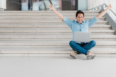 Full length of young man using mobile phone