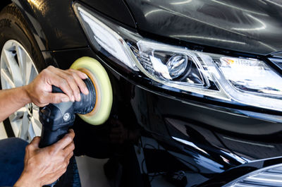 Close-up of man hand holding car