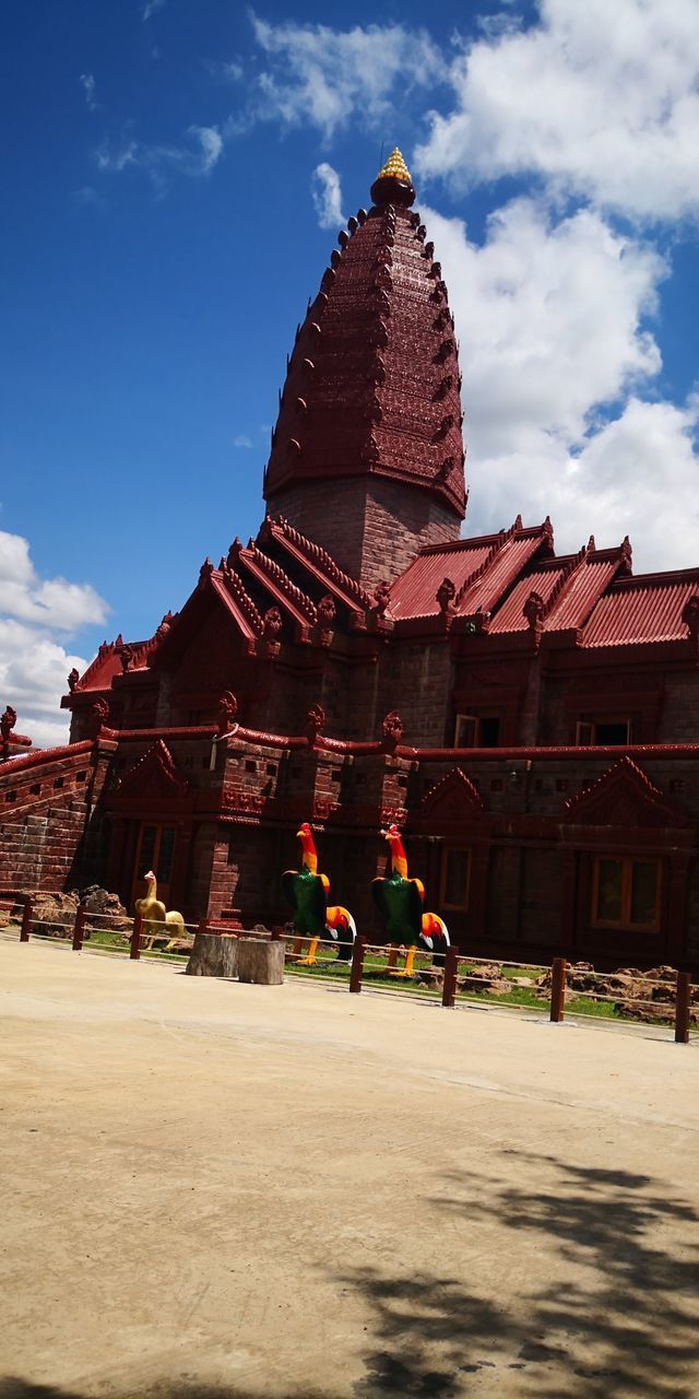 PEOPLE AT TEMPLE AGAINST BUILDING