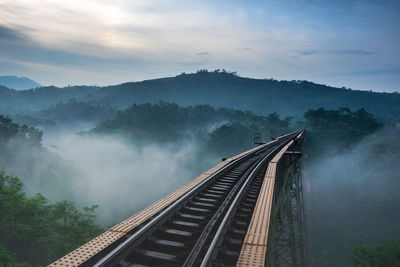 High angle view of railway bridge against mountains during sunset