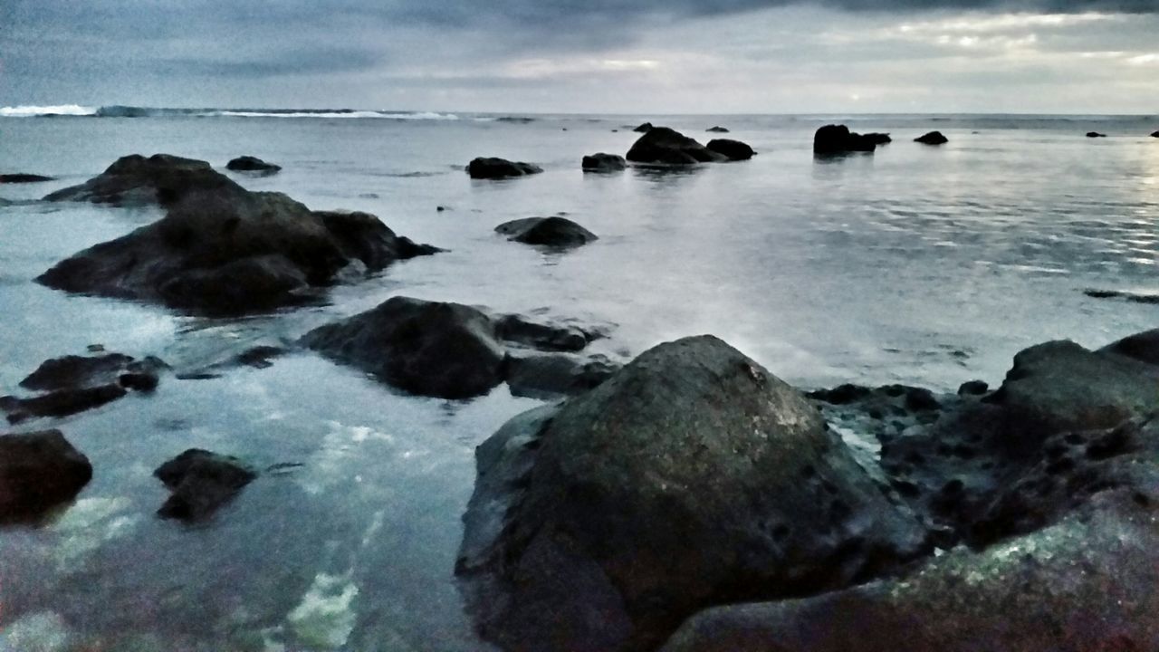 sea, water, horizon over water, rock - object, beach, sky, scenics, tranquil scene, shore, beauty in nature, tranquility, nature, wave, cloud - sky, rock formation, rock, idyllic, surf, coastline, outdoors