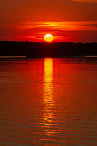 Scenic view of sea against romantic sky at sunset