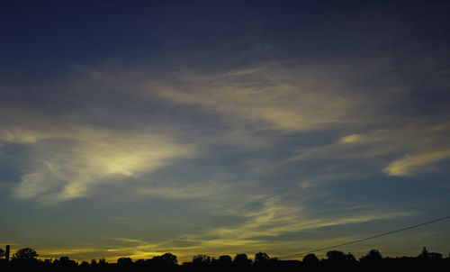 Low angle view of silhouette trees against sky at sunset