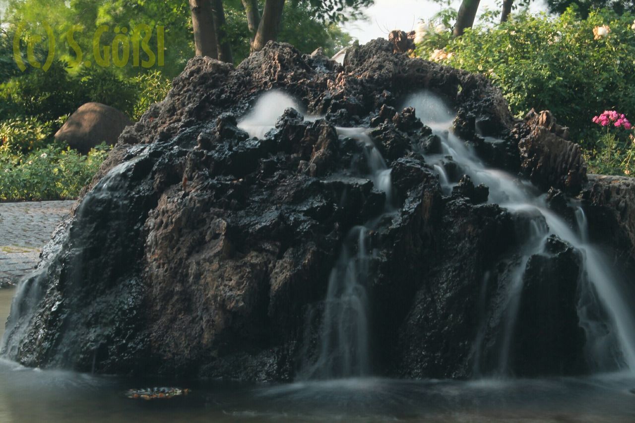 water, motion, flowing water, waterfall, tree, long exposure, rock - object, flowing, forest, splashing, nature, beauty in nature, waterfront, scenics, blurred motion, river, sunlight, outdoors, growth, day