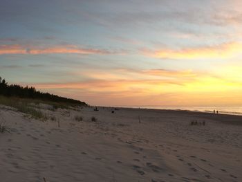 Scenic view of beach against sky during sunset