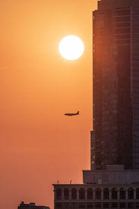 Silhouette building against sky during sunset