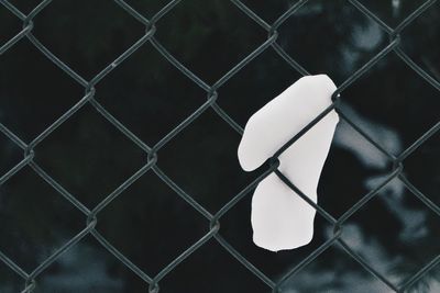 Close-up of number on chainlink fence