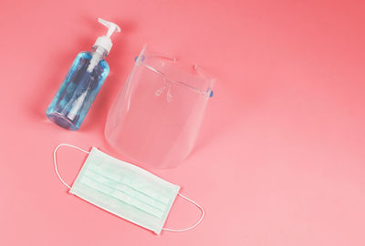 High angle view of bottle against pink background