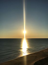 Scenic view of sea against clear sky at sunset