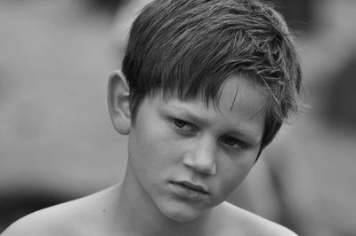 Close-up of shirtless boy looking away