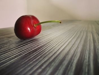 Close-up of red fruits on wooden table