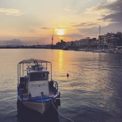 Boats in harbor at sunset