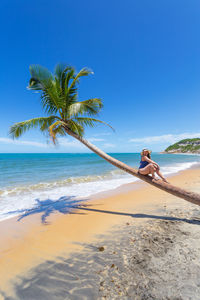 Scenic view of beach against clear blue sky