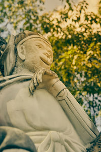 Statue of buddha against plants